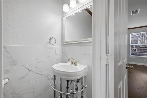 a bathroom with a sink a mirror and a shower