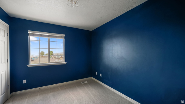 983 South 1850th Street West Springville, UT 84663 - Photo 13 of 30 Room featuring a large grid-pattern window, plush carpeting, and bold blue painted walls