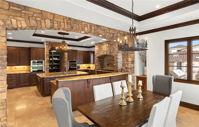 a kitchen with stainless steel appliances kitchen island granite countertop a sink and a stove
