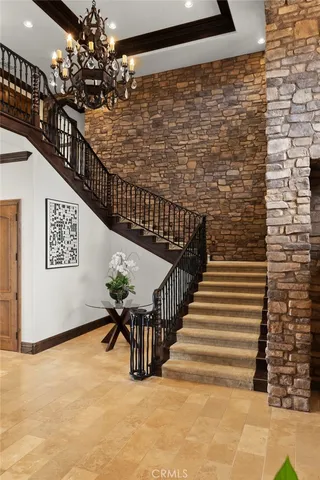 a bedroom with a large bed and a chandelier