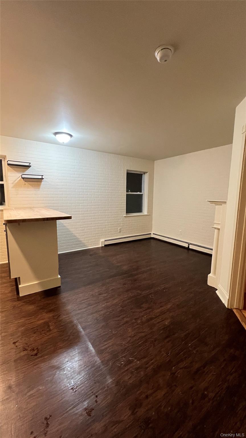 27 East Main Street, Unit 3 Beacon, NY 12508 - Photo 3 of 8 a view of an empty room with wooden floor and a window