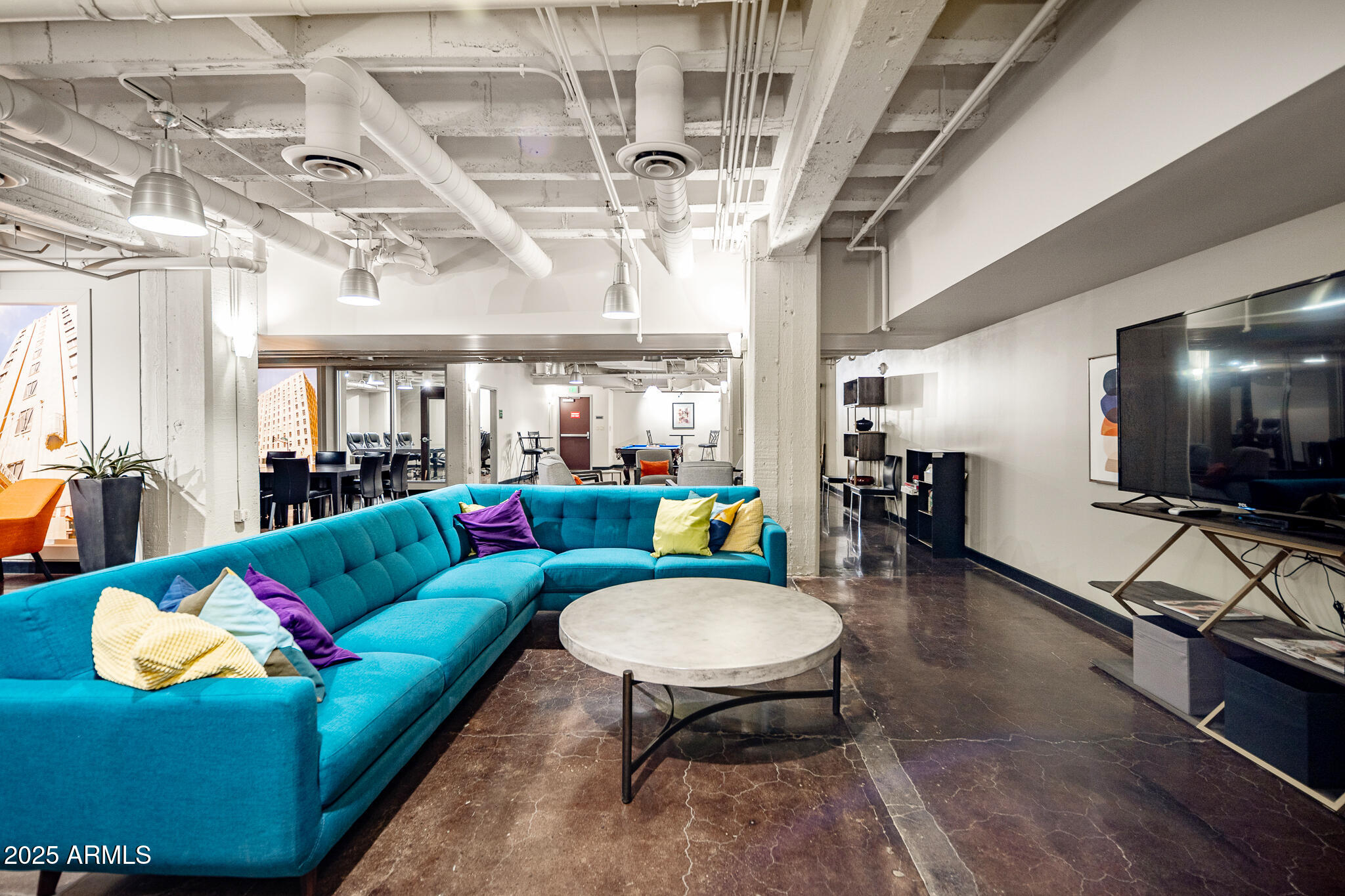 114 West Adams Street, Unit 402 Phoenix, AZ 85003 - Photo 19 of 25 a living room with furniture and a flat screen tv