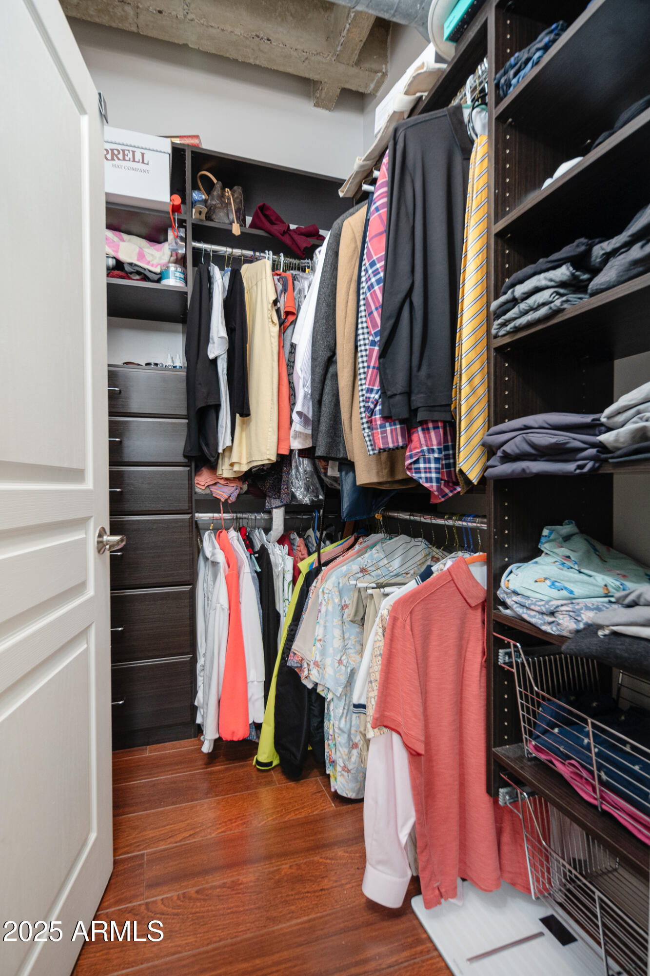 114 West Adams Street, Unit 402 Phoenix, AZ 85003 - Photo 22 of 25 a view of walk in closet with clothes and shoes