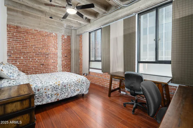 a large white kitchen with a stove a sink dishwasher a dining table and chairs with wooden floor