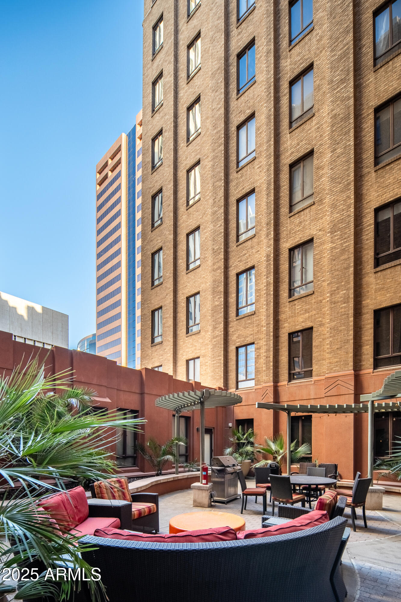 114 West Adams Street, Unit 402 Phoenix, AZ 85003 - Photo 6 of 25 a front view of a building with swimming pool and outdoor seating