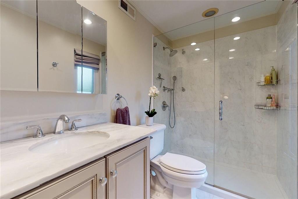 5 Foster Square Pittsburgh, PA 15212 - Photo 12 of 25 a bathroom with a sink a toilet and shower