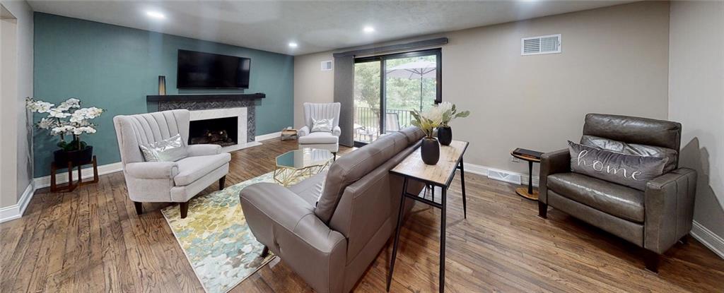 5 Foster Square Pittsburgh, PA 15212 - Photo 5 of 25 a living room with furniture a flat screen tv and a fireplace