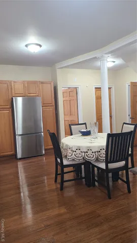 a dining room with furniture and wooden floor