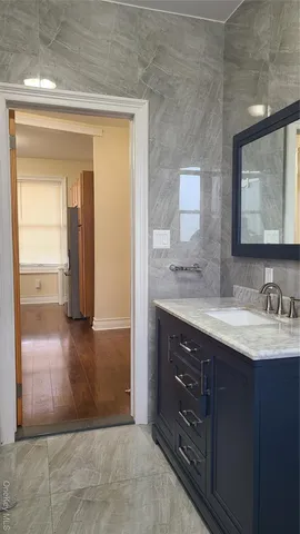a bathroom with a granite countertop sink a mirror and a vanity