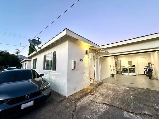 a view of a house with a big yard and sitting area