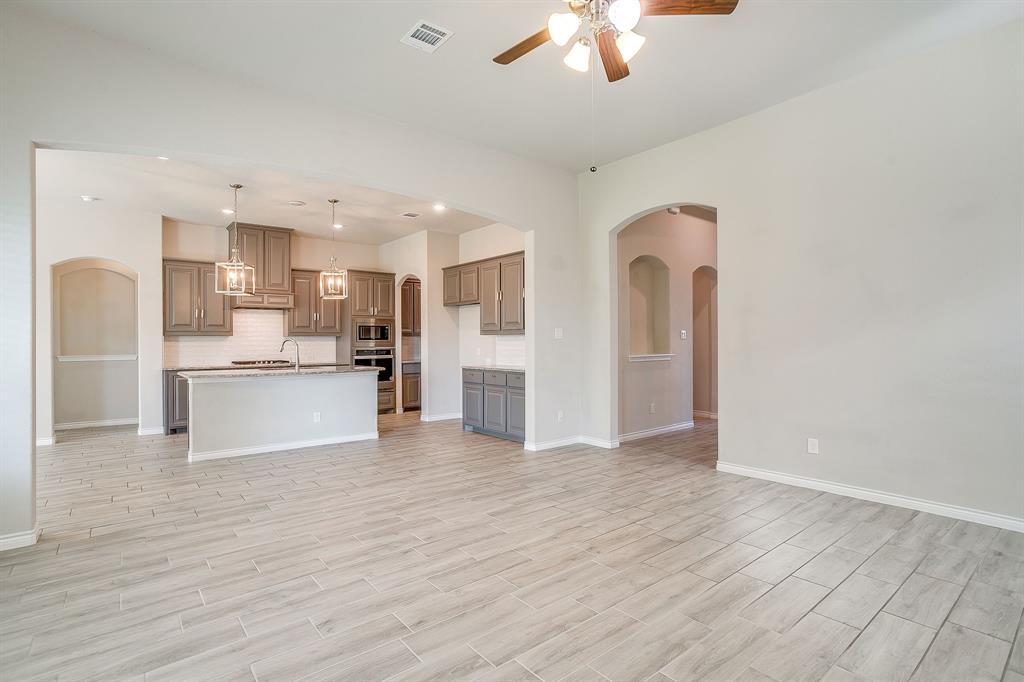 1281 Palo Duro Court Burleson, TX 76028 - Photo 12 of 39 a view of kitchen with kitchen island stainless steel appliances cabinets and wooden floor
