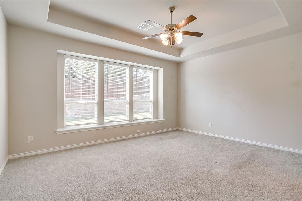 1281 Palo Duro Court Burleson, TX 76028 - Photo 24 of 39 an empty room with chandelier fan and windows