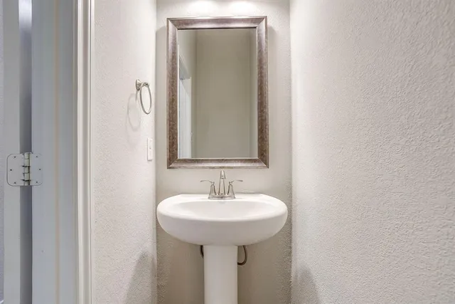 a bathroom with a sink a toilet and mirror