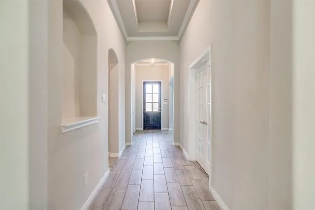 a view of a hallway with wooden floor