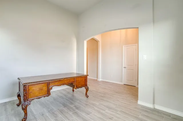 a room with a window and wooden floor