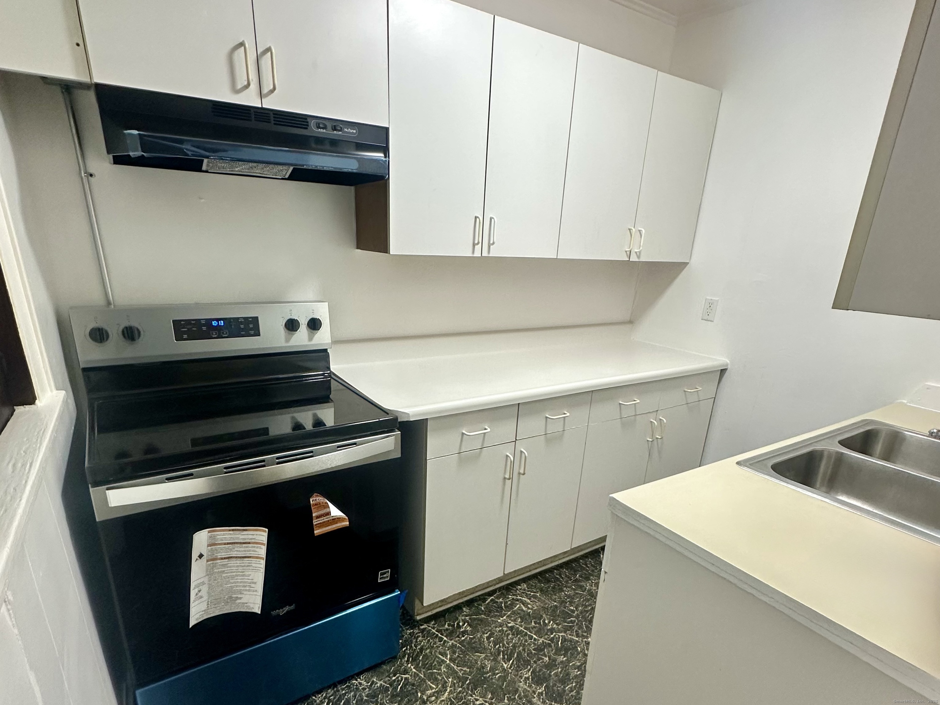 375 North Elm Street, Unit 2 Torrington, CT 06790 - Photo 2 of 9 a utility room with dryer and washer