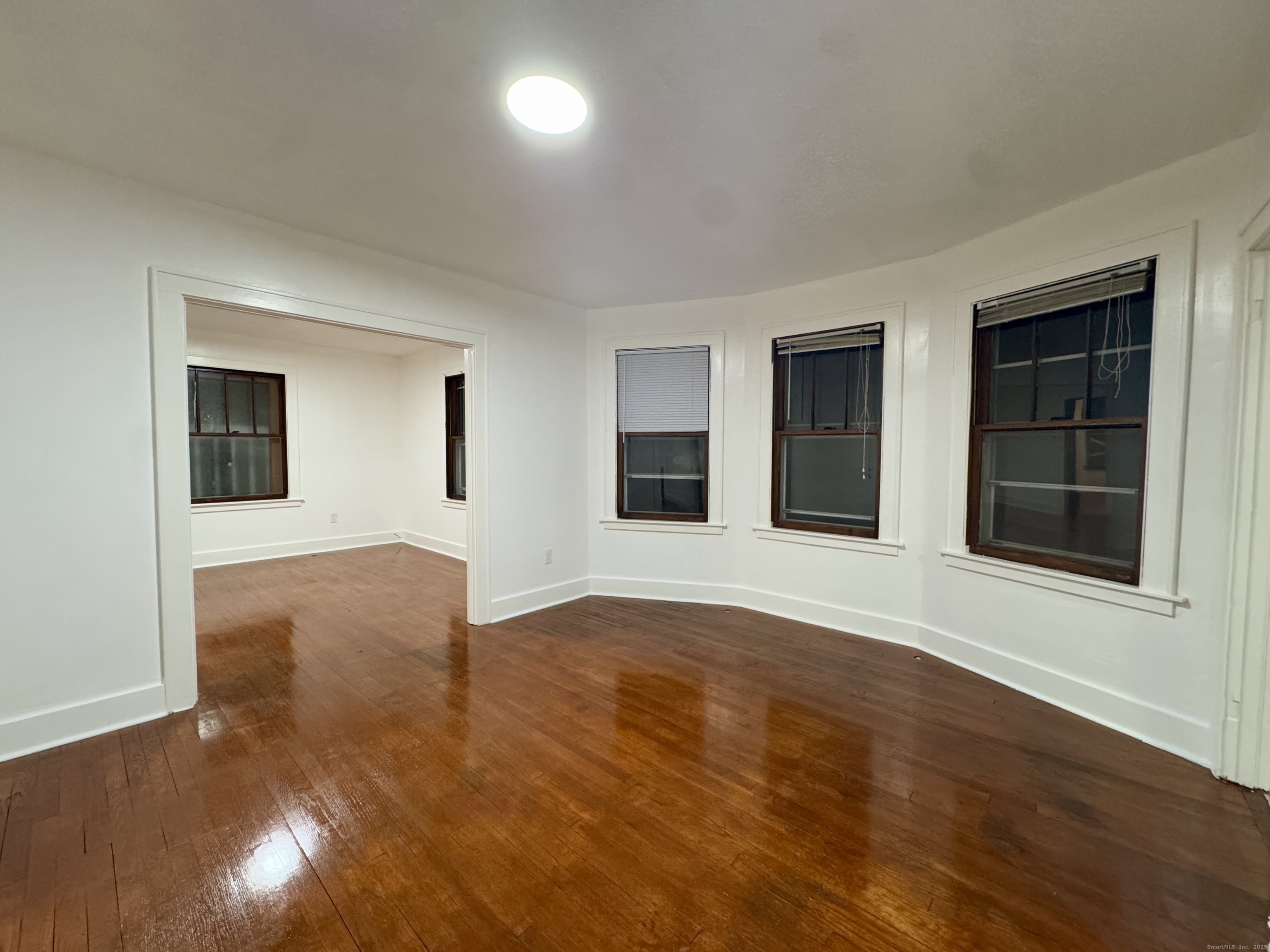 375 North Elm Street, Unit 2 Torrington, CT 06790 - Photo 5 of 9 a view of empty room with wooden floor and fan
