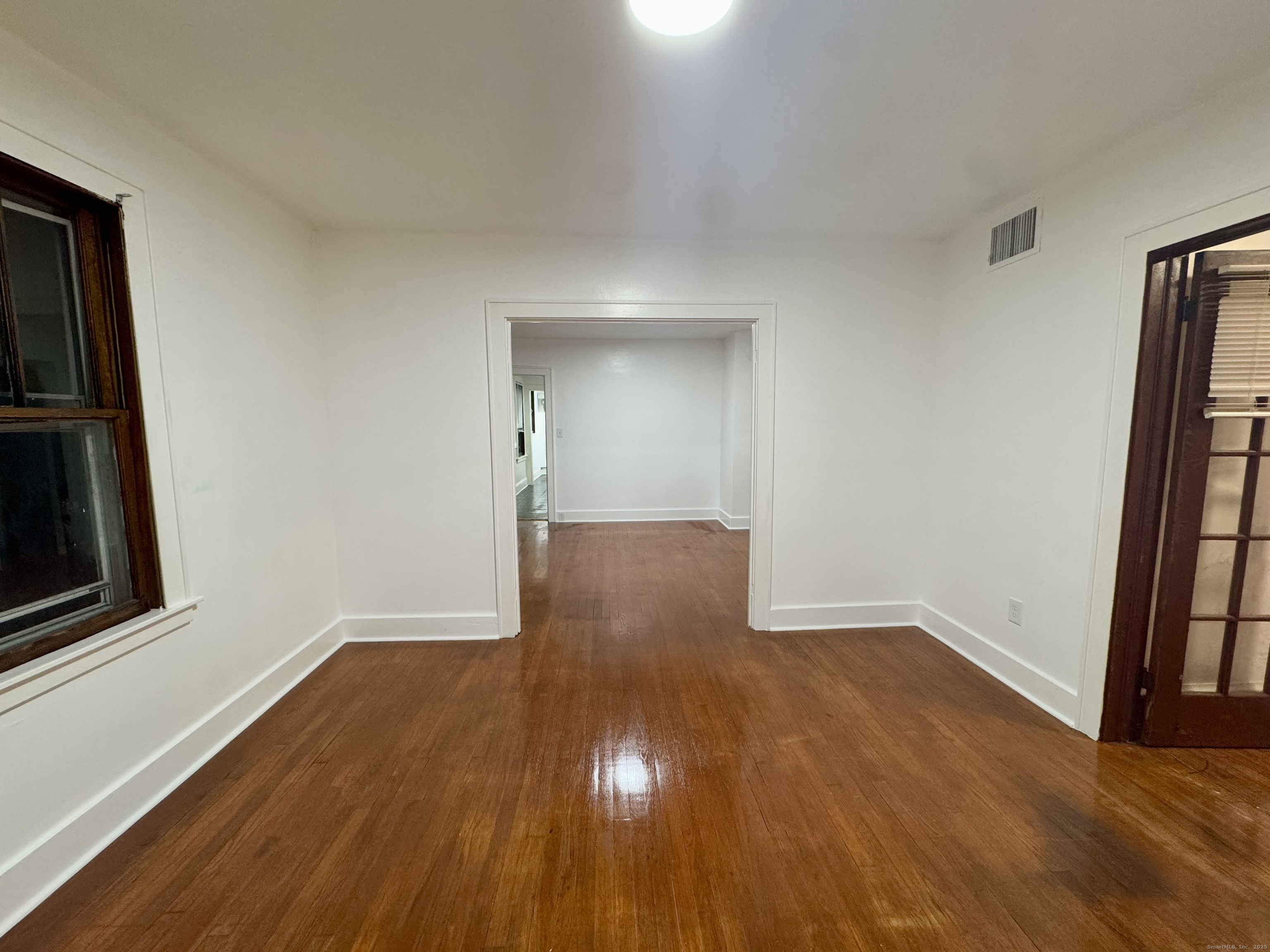 375 North Elm Street, Unit 2 Torrington, CT 06790 - Photo 6 of 9 a view of an empty room with wooden floor and a window
