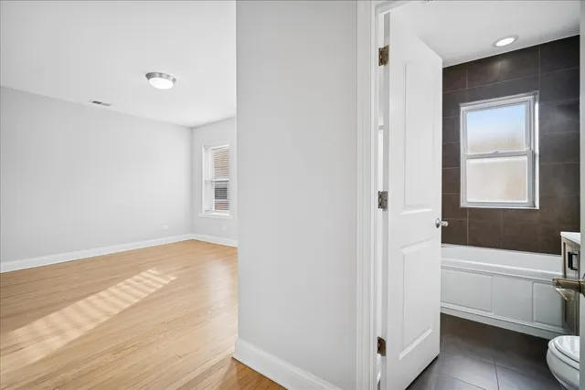 a view of bathroom with bathtub wooden floor and shower