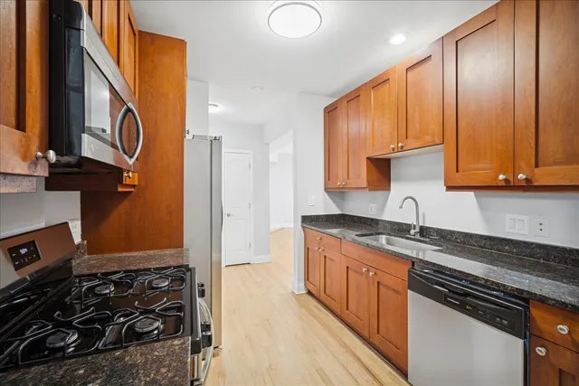 a kitchen with a stove a sink and a cabinets