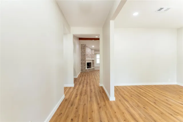 a view of a room with wooden floor