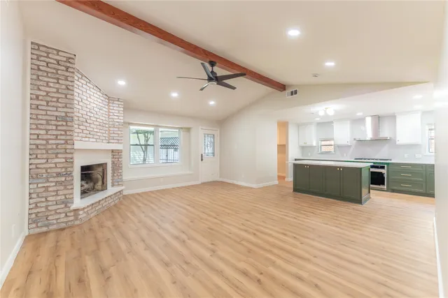 a view of kitchen with granite countertop window and a fireplace