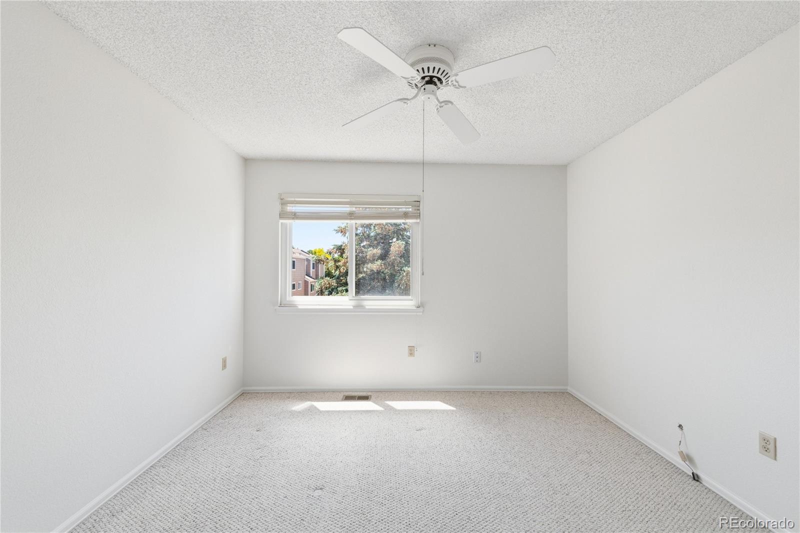 155 Blue Spruce Court Highlands Ranch, CO 80126 - Photo 20 of 29 an empty room with a window and a ceiling fan