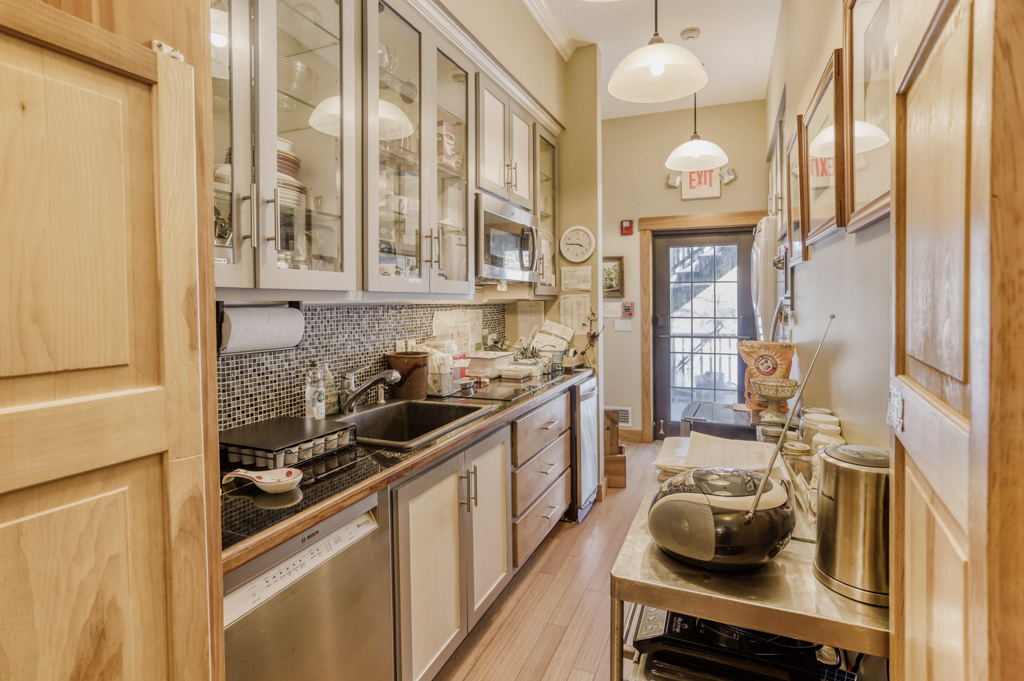 24 Cournoyer Road West Tisbury, MA 02568 - Photo 4 of 11 a kitchen with stainless steel appliances granite countertop a sink and cabinets