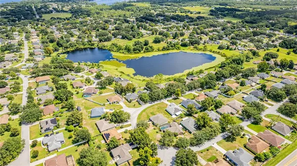 an aerial view of residential houses with yard