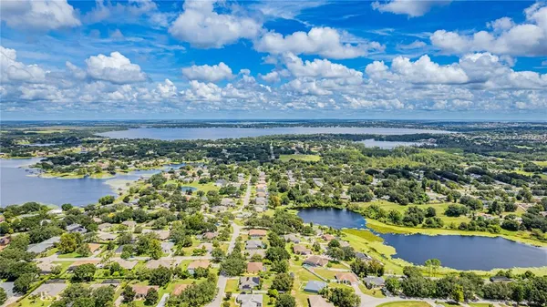 a view of a yard with wooden fence