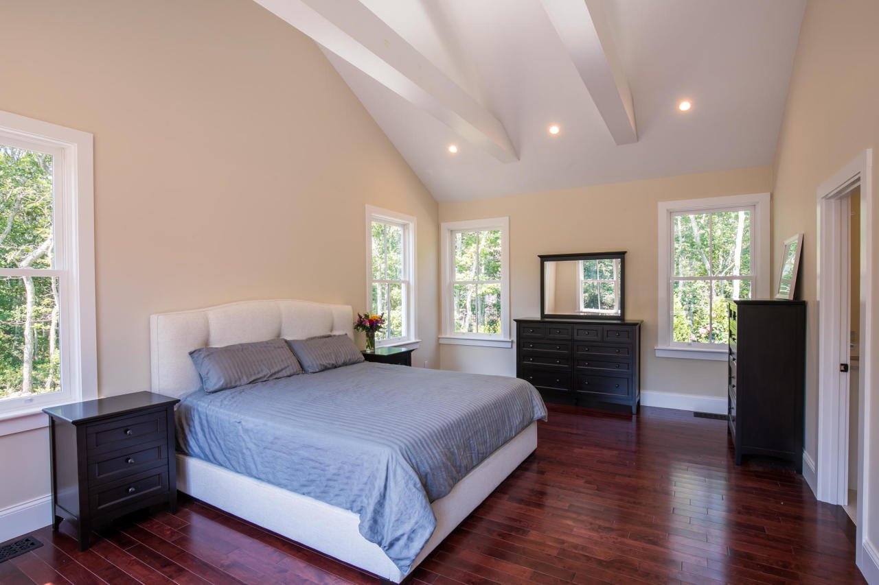 28 Fishermans Knot Road Edgartown, MA 02539 - Photo 15 of 30 a spacious bedroom with a large bed and wooden floor