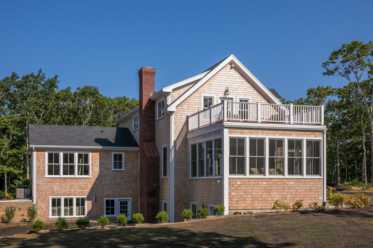 28 Fishermans Knot Road Edgartown, MA 02539 - Photo 29 of 30 a front view of a house with a yard and garage