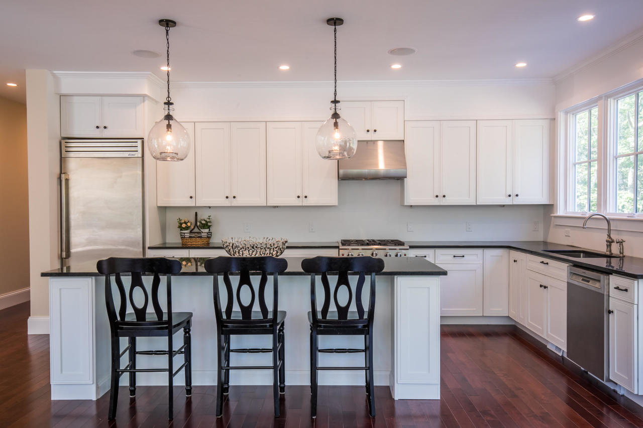 28 Fishermans Knot Road Edgartown, MA 02539 - Photo 7 of 30 a kitchen with stainless steel appliances granite countertop a stove a refrigerator a kitchen island a table and chairs with wooden floor