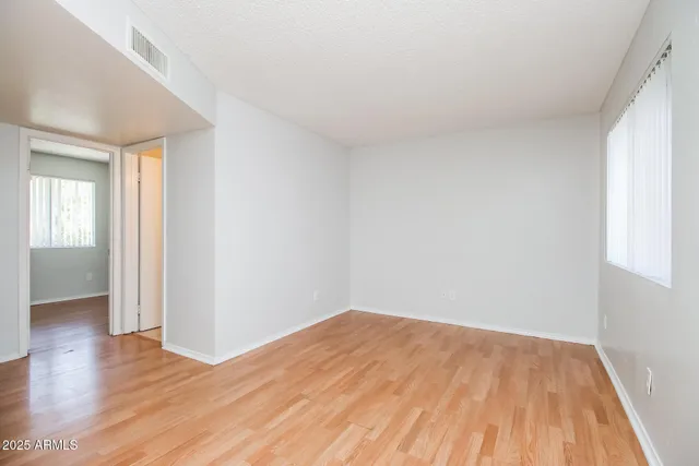 a view of empty room with wooden floor