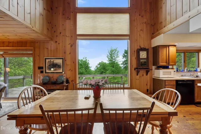 a kitchen with a stove a sink dishwasher and a refrigerator with wooden floor