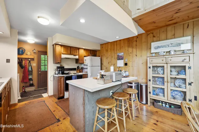 a bedroom with a bed and a flat tv screen on the dresser