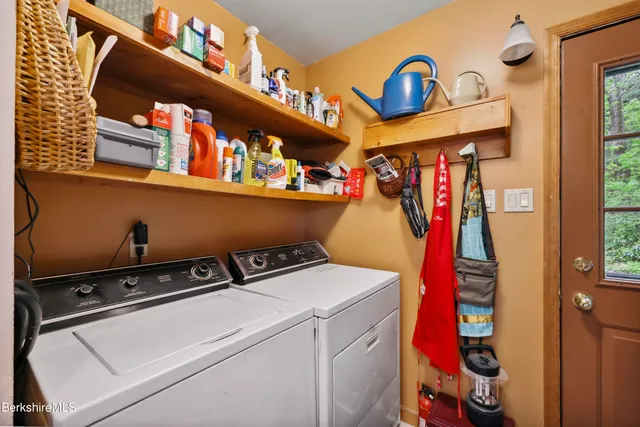 a bathroom with a double vanity sink mirror and shower