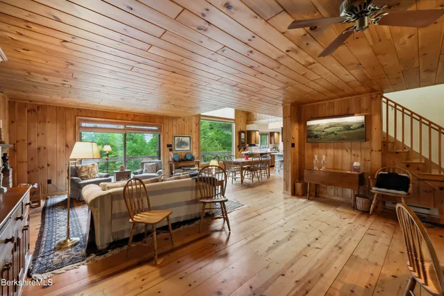 a living room with furniture a rug and a bookshelf