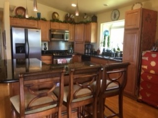170 Naalae Road Kula, HI 96790 - Photo 7 of 23 a kitchen with a table chairs refrigerator and microwave