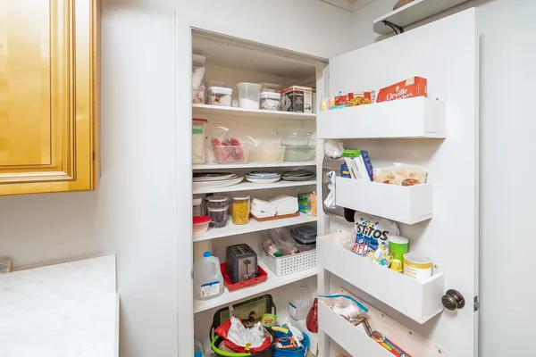 a kitchen with stainless steel appliances granite countertop a refrigerator a sink dishwasher a stove with wooden cabinets and floor