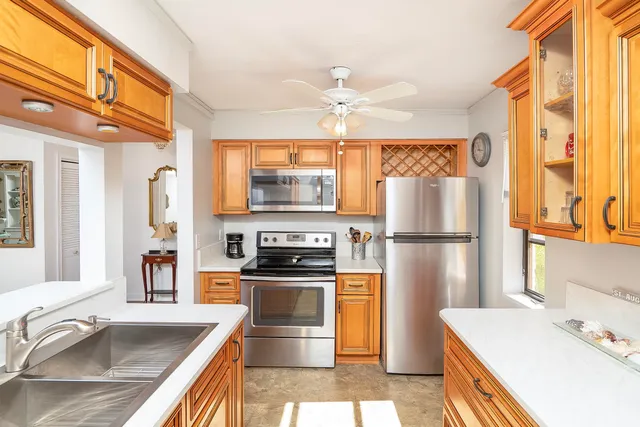 a kitchen with a sink a stove and cabinets