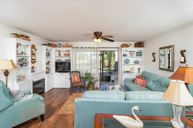 a living room with furniture and kitchen view