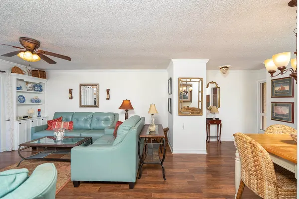 a living room with furniture fireplace and a large window