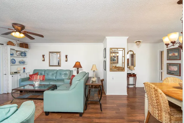 a living room with furniture fireplace and a large window
