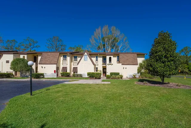 a view of a house with a tree