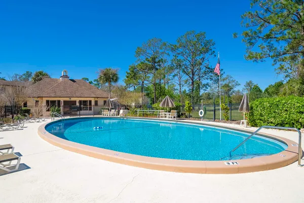 a view of a dining room with furniture and a chandelier