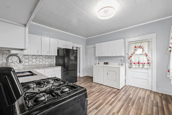 a kitchen with a stove and a refrigerator