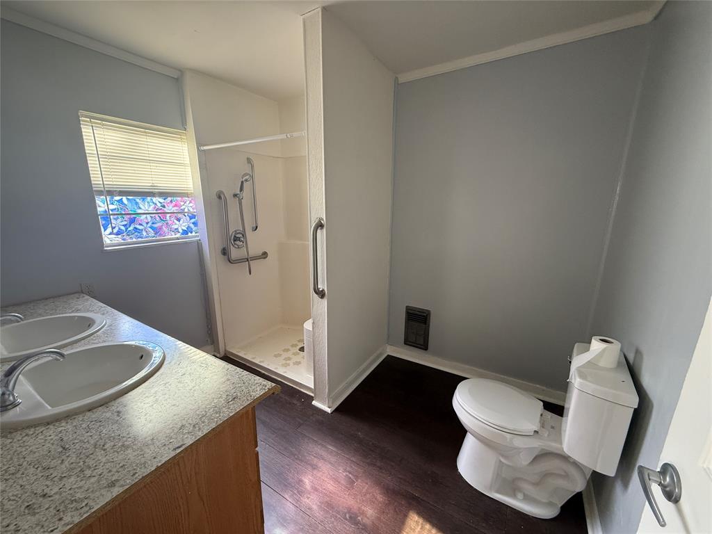 501 Needham Street Coleman, TX 76834 - Photo 11 of 16 a bathroom with a granite countertop sink and a mirror