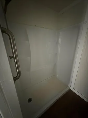 an empty room with a wooden floor and door