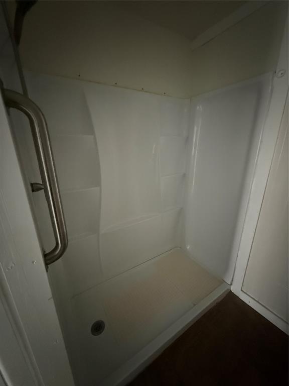 501 Needham Street Coleman, TX 76834 - Photo 15 of 16 an empty room with a wooden floor and door